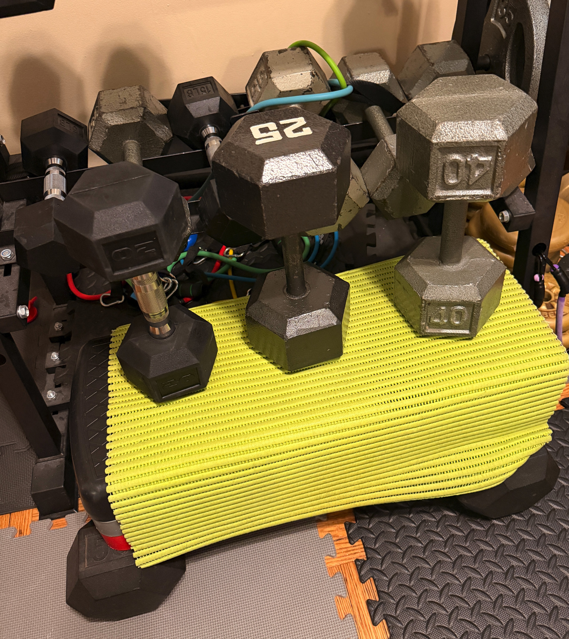 A range of heavy dumbbells in John’s home gym